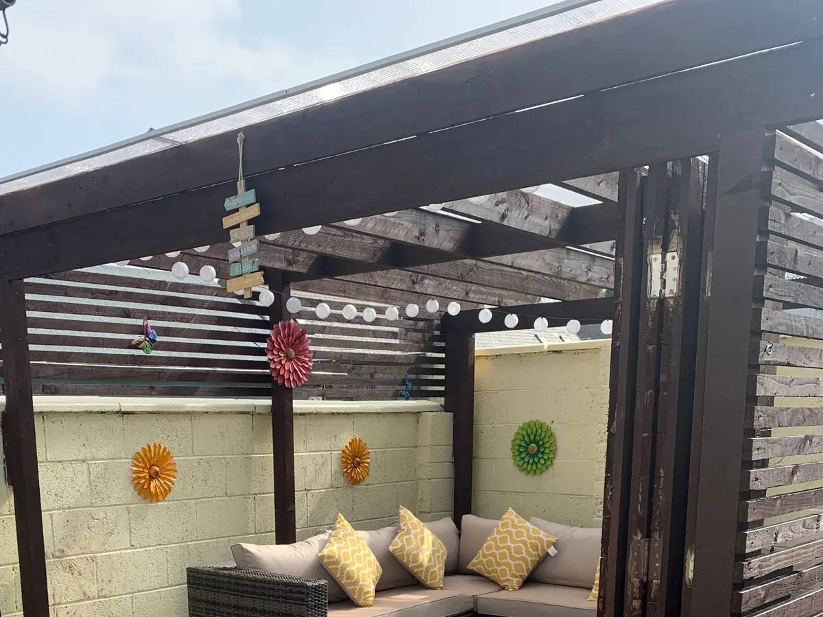 Covered outdoor seating area with slatted timber screening and tiled floor